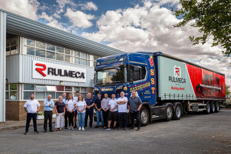 Rulmeca UK Ltd staff outside HQ with brandedLorry
